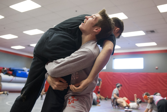 Dawson Downing, right, 17, lifts Matthew Alejandro, 18, during a wrestling practice at Arbor ...