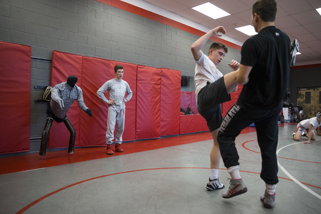 Dawson Downing, left, 17, watches his teammates wrestle during a practice at Arbor View High ...