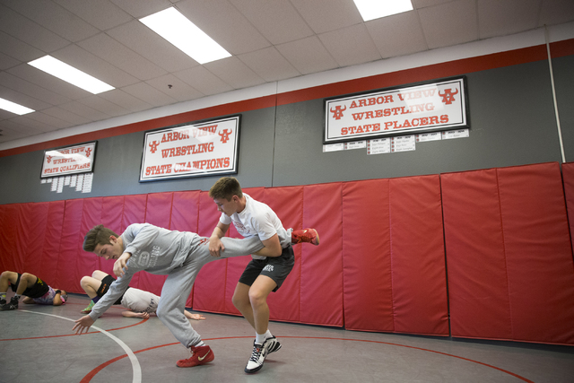 Dawson Downing, left, 17, and Ryder Marchello, 17, wrestle during practice at Arbor View Hig ...