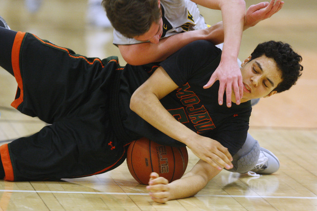 Clark guard Carter Olsen and Mojave guard Malik Abbott chase down a loose ball on Tuesday. C ...