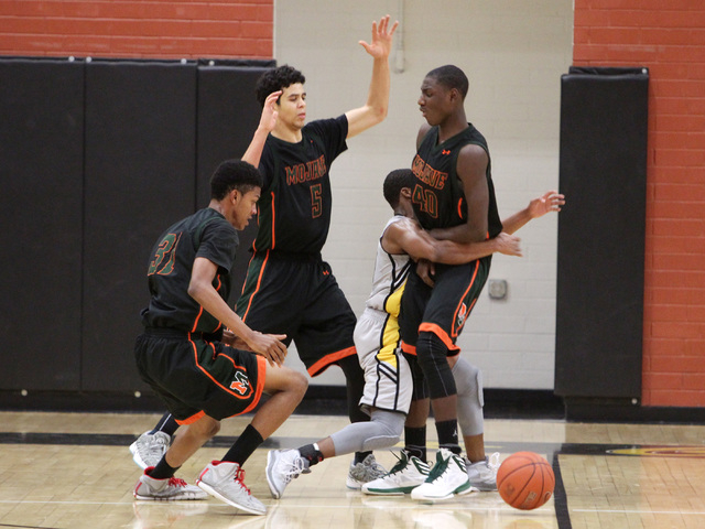 Clark guard Colby Jackson runs into Mojave’s Marcus Jackson and loses the ball on thei ...