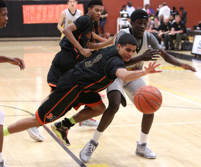 Mojave’s Darryl Adams, left, knocks the ball away from Clark’s Wilson Samuel on ...
