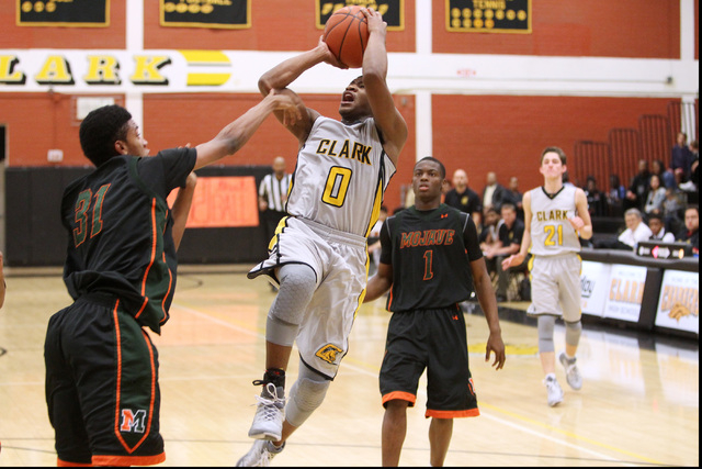Clark guard Colby Jackson shoots over Mojave’s Jordan Glenn on Tuesday. Clark won 52-4 ...