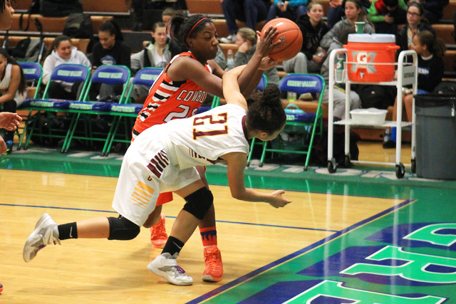 Chaparral guard Marcia Hawkins and Dimond guard Shameah Jones chase a loose ball during thei ...