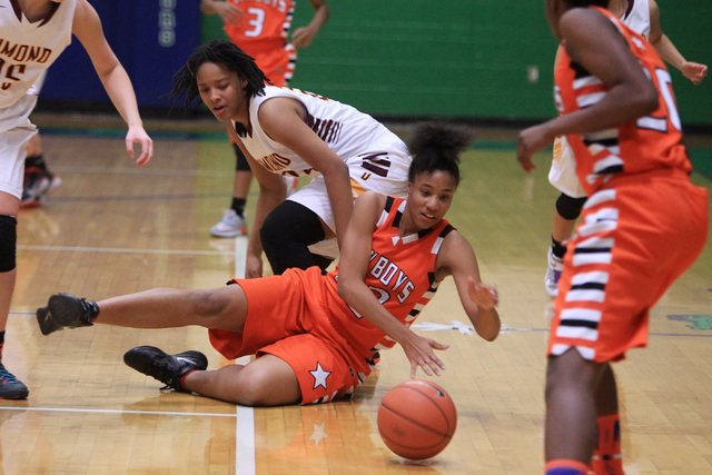 Chaparral center Jade Hazelton rolls a loose ball away from Dimond during the Gator Winter C ...