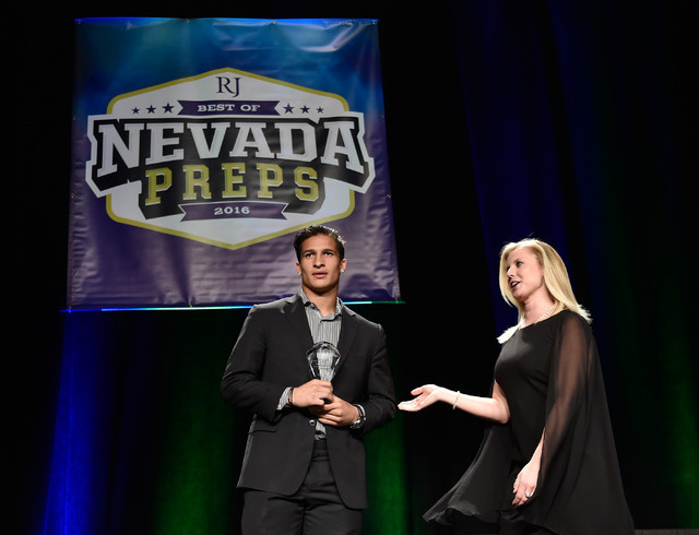 Bishop Gorman’s Biaggio Ali Walsh, left receives his top male athlete award at the Bes ...