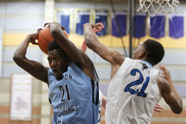 Canyon Springs forward D’Quan Crockett grabs a rebound from Foothill forward Torrance ...