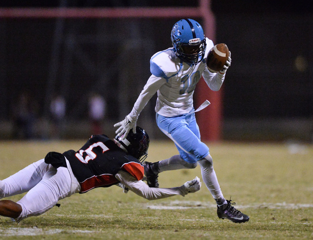 Canyon Springs wide receiver Keyon White (10) breaks a tackle during the Las Vegas High Scho ...