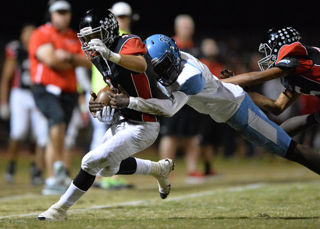 Las Vegas receiver Nick Sablan (4) is tackled out of bounds during the Las Vegas High School ...