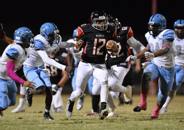 Las Vegas quarterback Zach Matlock (12) runs the football during the Las Vegas High School C ...