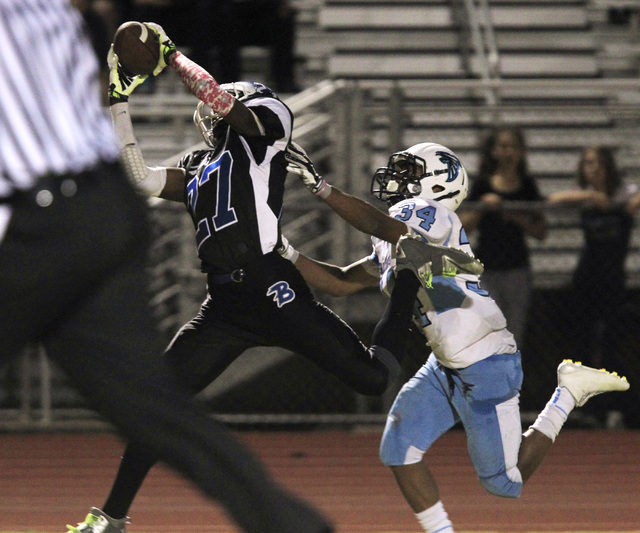 Basic wide receiver Josh Villaros pulls in a touchdown pass while being covered by Foothill ...