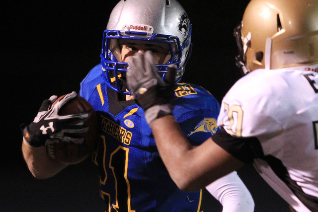 Pahranagat Valley running back Jordan Cryts looks for a way around Spring Mountain guard Sea ...