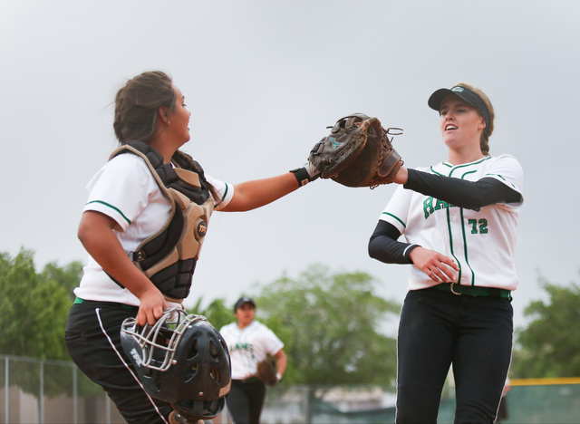 Samantha Pochop (72), right, high-fives the catcher after ending an inning during a game bet ...