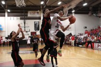 Las Vegas forward Tyler Bey drives to the basket and is fouled by Valley forward Shea Garlan ...