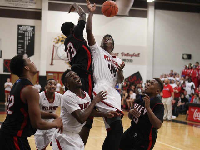 Valley forward Nick Brannon blocks a shot by Las Vegas forward Will Loche during their " ...