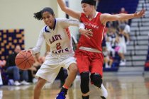 Bishop Gorman sophomore Shaira Young (2) dribbles the ball past a defender during the Las Ve ...