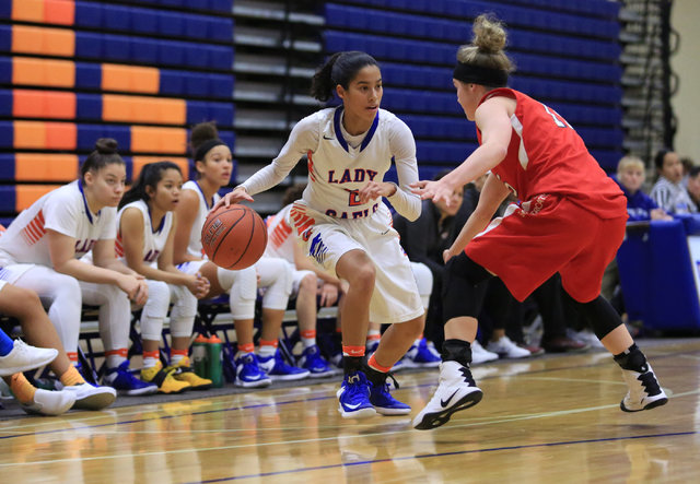 Bishop Gorman sophomore Shaira Young (2) dribbles the ball past a defender during the Las Ve ...