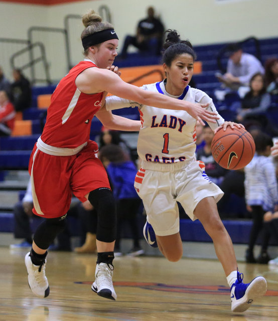 Bishop Gorman sophomore Caira Young (1) dribbles the ball past a defender during the Las Veg ...