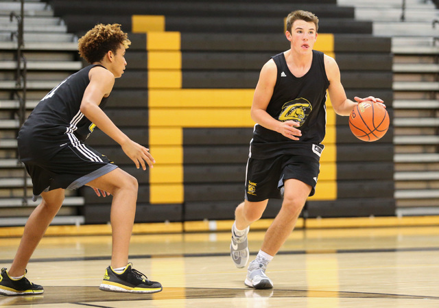 Clark guard James Bridges, right, runs a drill during practice at Ed W. Clark High School in ...