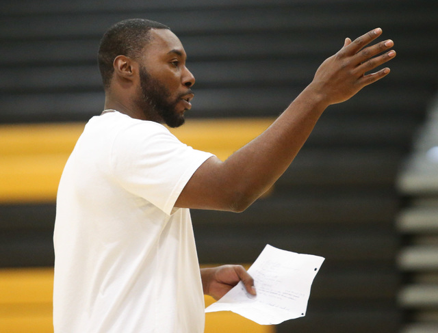 Clark High School basketball head coach Colin Darfour talks to his team during practice at E ...