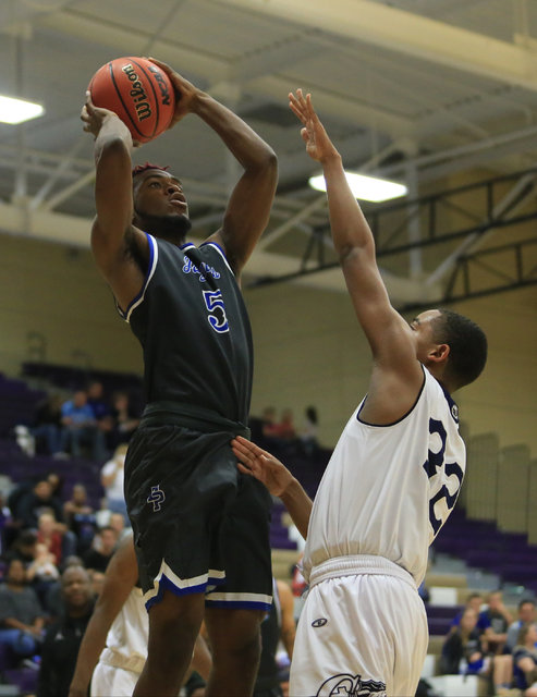 Desert Pines senior Javell Watkins (5) takes a shot during the Class 3A boys regional basket ...