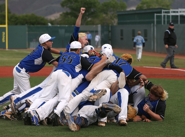 The Basic Wolves celebrate their 9-1 win over Centennial for the NIAA DI baseball championsh ...