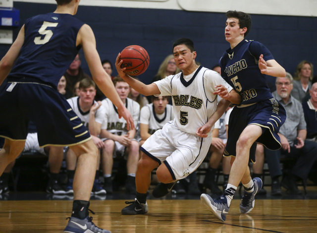 Lake Mead’s Kai Madela (5) drives to the basket past Rancho Solano’s Hunter Ruck ...