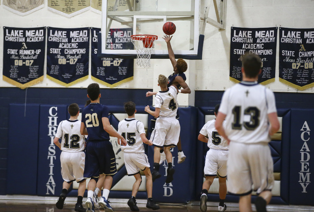 Rancho Solano’s Kiimani Holt (30) gets a shot in during a basketball game at Lake Mead ...
