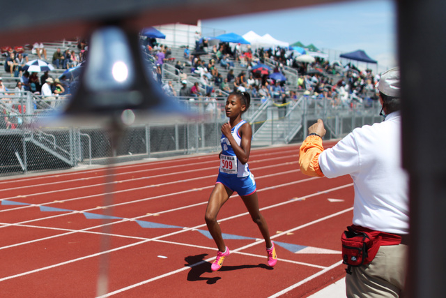 Centennial freshman distance runner Alexis Gourrier hits the bell lap in the 1,600 during th ...