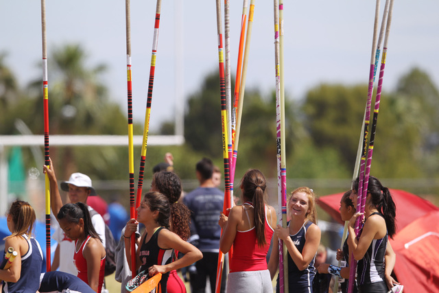 Girls pole vaulters wait to practice during the Sunrise and Sunset Region track finals Satur ...