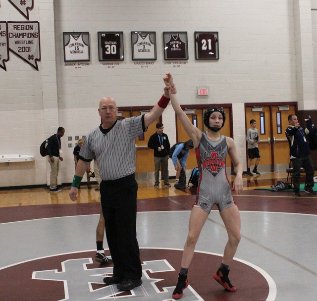 Referee Mike Guerino raises the arm of Arbor View 106-pounder Peyton Prussin after winning h ...