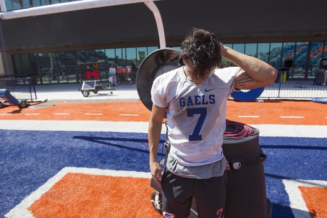 Bishop Gorman running back Baggio Ali Walsh (7) cools off after a scrimmage during team prac ...