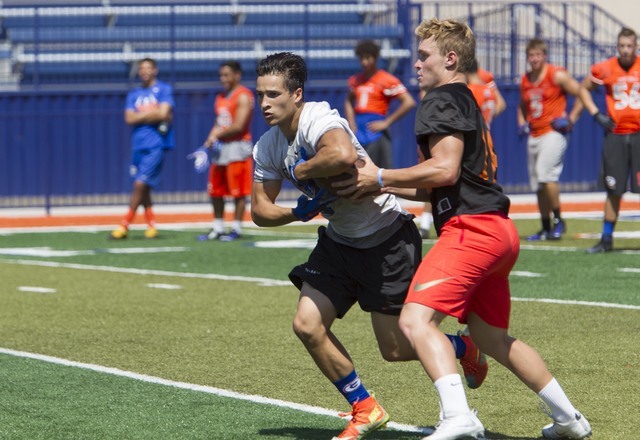 Bishop Gorman running back Baggio Ali Walsh, left, (7) fakes a catch during team practice at ...