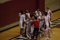 Desert Oasis’ Ron Chan is mobbed by teammates after scoring his first points of the se ...