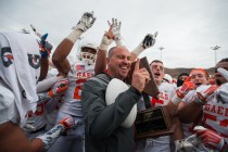 Bishop Gorman head coach Tony Sanchez celebrates with his team after winning the NIAA Divisi ...