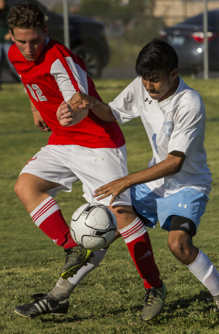 Arbor View junior midfielder Nicklaus Dongmannon (12) fights for possession with Canyon Spri ...