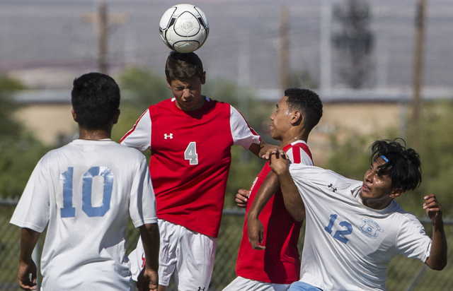 Arbor View sophomore midfielder Hayden Turnier (4) leaps for a header over Canyon Springs ju ...