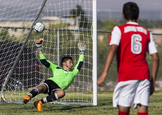 Arbor View senior goal keeper Brendan Rapp (0) attempts to stop a shot as freshman midfielde ...