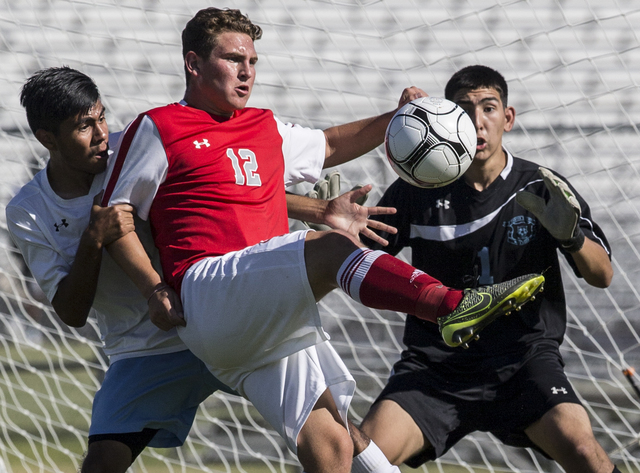 Arbor View junior midfielder Nicklaus Dongmannon (12) turns and shoots on Canyon Springs jun ...