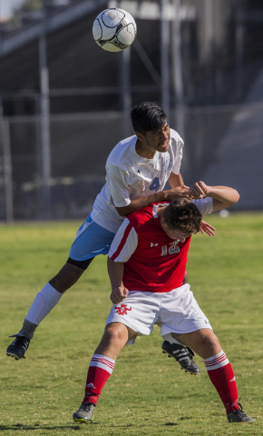 Canyon Springs senior defender Alejandro Reveles (4) fights for a header with Arbor View jun ...