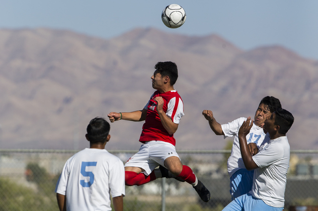 Arbor View sophomore forward Marcos Martinez (11) fights for possession with Canyon Springs ...