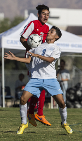 Canyon Springs junior midfielder Edgar Muniz (9) fights for possession with Arbor View junio ...