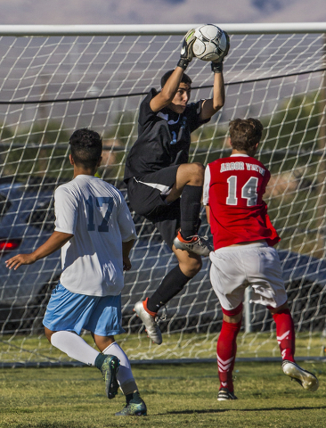Canyon Springs junior goal keeper Gabriel Acosta (1) leaps to make a save over Arbor View ju ...
