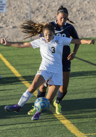 Faith Lutheran defender Isabella Gutierrez (3) dribbles the ball upfield past a Centennial p ...