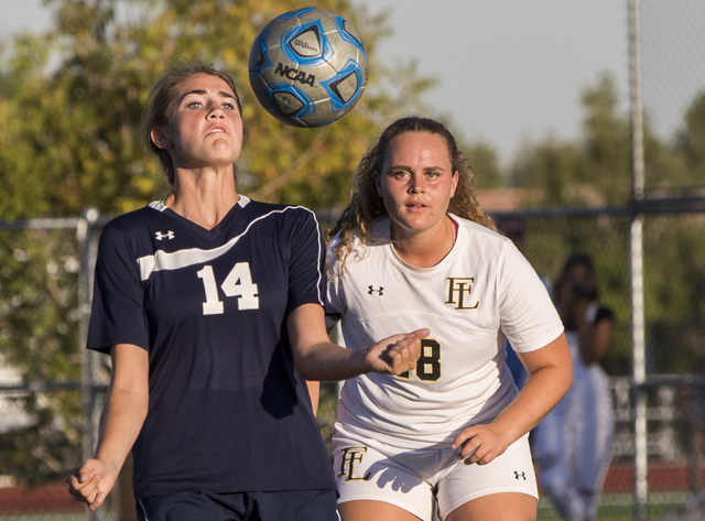 Centennial’s McKenna Stratton (14) fights for a ball with Faith Lutheran’s Brook ...