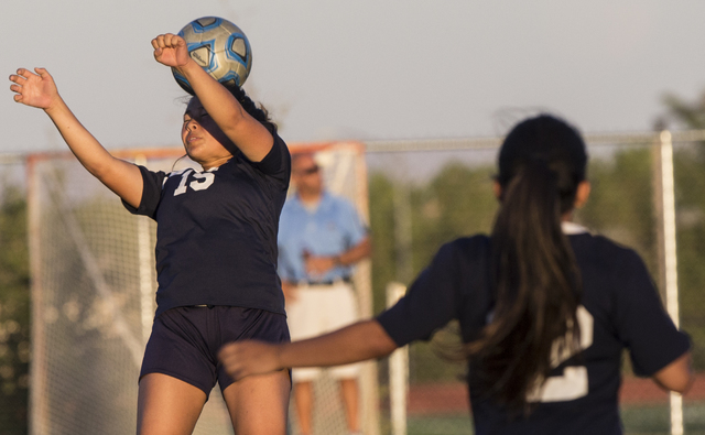 Centennial’s Victoria Cera (15) heads a ball out of danger during her team’s roa ...