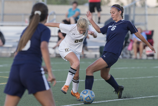 Centennial’s Lauren Levoyer (6) fights for a ball with Faith Lutheran’s Amelia M ...