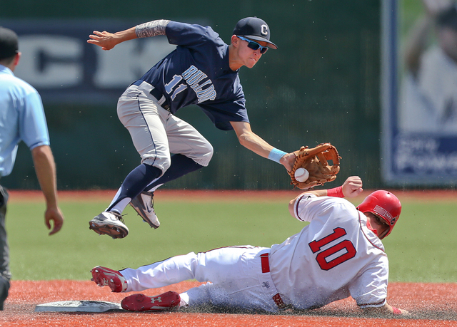 Liberty’s Dan Skelly steals safely under the tag of Centennial’s Tanner Wright d ...