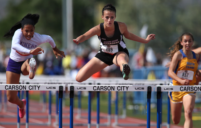 Sunrise Mountain’s Brittany Veal, left, runs in the 100-meter hurdles during the Divis ...