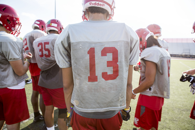 Arbor View High School wide receiver and cornerback Michael Sims, center, walks to a huddle ...